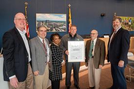 Montgomery Parks park manager Tom Baker holds the certificate that honors him for his help with the plane crash. Others in the photo are Director of Parks Mike Riley, Interim Planning Board Commissioners Robert Pinero and Cherri Branson, Interim Planning Board Chair Jeffrey Zyontz and Interim Planning Board Commissioner David Hill. (Courtesy Maryland-National Capital Park and Planning Commission)